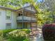 Two-story condo with a gray exterior, a lattice-covered porch, and lush landscaping at 1234 Weatherstone Ne Dr, Atlanta, GA 30324