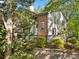Charming home exterior featuring a brick accent and gray wood, complemented by mature trees and landscaping at 1234 Weatherstone Ne Dr, Atlanta, GA 30324