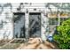 Exterior shot of two gray doors and a small window with a home security sign displayed at 1234 Weatherstone Ne Dr, Atlanta, GA 30324