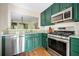 Galley kitchen featuring emerald colored cabinets and stainless steel appliances at 1234 Weatherstone Ne Dr, Atlanta, GA 30324