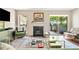Sunlit living room with a fireplace, hardwood floors, and a sliding glass door to the patio at 1234 Weatherstone Ne Dr, Atlanta, GA 30324