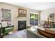 Cozy living room with a fireplace, hardwood floors, and access to an outdoor patio at 1234 Weatherstone Ne Dr, Atlanta, GA 30324