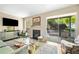 Bright living room featuring a fireplace, hardwood floors, and a sliding glass door to the patio at 1234 Weatherstone Ne Dr, Atlanta, GA 30324
