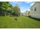 Large backyard with well-maintained lawn, surrounded by trees and a chain-link fence, offering a private outdoor space at 1248 To Lani Ct, Stone Mountain, GA 30083