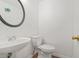 Bathroom featuring a pedestal sink and toilet with laminate flooring at 1248 To Lani Ct, Stone Mountain, GA 30083