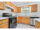 Functional kitchen with wood cabinets and modern appliances at 1248 To Lani Ct, Stone Mountain, GA 30083