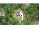 Aerial view of a home with verdant surroundings and a winding driveway, offering privacy and curb appeal at 1761 Mcdaniel Mill Rd Sw, Conyers, GA 30094
