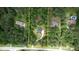 Aerial view of a home surrounded by dense trees, showcasing its secluded location and spacious lot at 1761 Mcdaniel Mill Rd Sw, Conyers, GA 30094