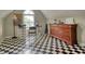Attic with black and white checkered floors, large dresser, desk with accessories, and plenty of natural light at 1761 Mcdaniel Mill Rd Sw, Conyers, GA 30094