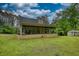 A spacious backyard showcases a porch, lush green grass, and a shed in a tranquil outdoor setting at 1761 Mcdaniel Mill Rd Sw, Conyers, GA 30094