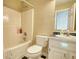 Bathroom with shower-tub combination, toilet and vanity with black countertop at 1761 Mcdaniel Mill Rd Sw, Conyers, GA 30094