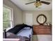 Cozy bedroom features a unique daybed, dresser, and round mirror, creating a warm and inviting space at 1761 Mcdaniel Mill Rd Sw, Conyers, GA 30094
