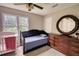 Well-lit bedroom with dresser, crib, and plush carpet at 1761 Mcdaniel Mill Rd Sw, Conyers, GA 30094