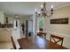Open dining room with access to the kitchen, complemented by natural light and a chandelier at 1761 Mcdaniel Mill Rd Sw, Conyers, GA 30094
