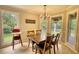 Bright dining area with a classic chandelier and lovely view to the backyard at 1761 Mcdaniel Mill Rd Sw, Conyers, GA 30094