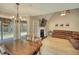 Well-lit dining area with views to the backyard, hardwood floors and stylish chandelier at 1761 Mcdaniel Mill Rd Sw, Conyers, GA 30094