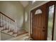 Elegant entryway featuring a wooden front door and staircase at 1761 Mcdaniel Mill Rd Sw, Conyers, GA 30094