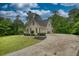 Traditional home featuring a long driveway and well-maintained lawn at 1761 Mcdaniel Mill Rd Sw, Conyers, GA 30094