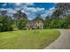 Home with landscaped lawn, long driveway, and charming details at 1761 Mcdaniel Mill Rd Sw, Conyers, GA 30094