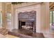 Elegant fireplace with stone facade and white mantle, perfect for cozy gatherings at 1761 Mcdaniel Mill Rd Sw, Conyers, GA 30094