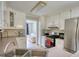 Functional kitchen with stainless steel appliances, white cabinets, and ample counter space at 1761 Mcdaniel Mill Rd Sw, Conyers, GA 30094