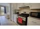 Well-equipped kitchen with white cabinetry, stainless steel appliances, and hardwood floors at 1761 Mcdaniel Mill Rd Sw, Conyers, GA 30094