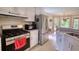 Bright kitchen with stainless steel refrigerator, gas range, and hardwood flooring at 1761 Mcdaniel Mill Rd Sw, Conyers, GA 30094