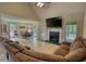 Open-concept living room featuring hardwood floors, fireplace, and seamless access to dining area at 1761 Mcdaniel Mill Rd Sw, Conyers, GA 30094