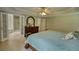 Main bedroom suite with ensuite bathroom, ceiling fan, and wood floors at 1761 Mcdaniel Mill Rd Sw, Conyers, GA 30094