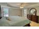 Comfortable primary bedroom suite with ceiling fan and ensuite bathroom at 1761 Mcdaniel Mill Rd Sw, Conyers, GA 30094