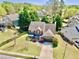 Aerial view of a charming home with a well-maintained lawn and mature trees in a suburban neighborhood at 3049 Battlement, Loganville, GA 30052