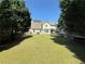Expansive backyard with mature trees, patio, trampoline offering a private outdoor space at 3049 Battlement, Loganville, GA 30052