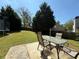 Outdoor patio with dining set overlooking a large, lush backyard with mature trees at 3049 Battlement, Loganville, GA 30052