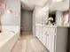 Bright bathroom featuring double sinks, a soaking tub, and neutral tile flooring at 3049 Battlement, Loganville, GA 30052