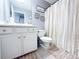 Well-lit bathroom featuring white cabinets and neutral tile flooring at 3049 Battlement, Loganville, GA 30052
