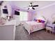 Adorable pink bedroom featuring a decorative ceiling, plush carpet, and ample storage at 3049 Battlement, Loganville, GA 30052