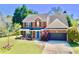 Attractive two-story home featuring a brick facade, well-kept lawn, and attached two-car garage at 3049 Battlement, Loganville, GA 30052