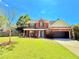 Charming two-story brick home featuring a well-manicured lawn and a two-car garage at 3049 Battlement, Loganville, GA 30052