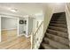 Inviting foyer with hardwood floors leading to carpeted stairs at 3049 Battlement, Loganville, GA 30052