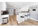 Kitchen with a breakfast bar featuring seating, white cabinets, and neutral countertops at 3049 Battlement, Loganville, GA 30052