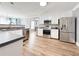 Modern kitchen with stainless steel appliances, light cabinets, and beautiful hardwood floors at 3049 Battlement, Loganville, GA 30052