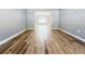 Open living room with hardwood floors, neutral gray walls and views into the dining room at 3049 Battlement, Loganville, GA 30052
