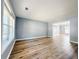 Spacious living room with wood floors, a large window, and neutral paint, creating a bright atmosphere at 3049 Battlement, Loganville, GA 30052