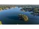 Scenic aerial view of a lake featuring a wooded island with a private dock at 5086 Cumberland Ct, Villa Rica, GA 30180