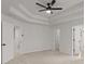 Spacious bedroom featuring plush carpet, tray ceiling, and dual closets at 5086 Cumberland Ct, Villa Rica, GA 30180