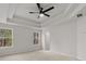 Spacious bedroom featuring plush carpet, tray ceiling, and large window at 5086 Cumberland Ct, Villa Rica, GA 30180