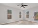 Bright bedroom with a ceiling fan, three large windows and a glass paneled door at 5086 Cumberland Ct, Villa Rica, GA 30180