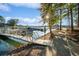 Scenic view of a boat dock surrounded by lush greenery and sparkling water on a sunny day at 5086 Cumberland Ct, Villa Rica, GA 30180