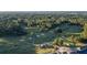 Panoramic aerial shot of the lush green community golf course nestled among the trees at 5086 Cumberland Ct, Villa Rica, GA 30180