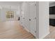 Hallway featuring a modern white interior, two doors, and light wood flooring at 5086 Cumberland Ct, Villa Rica, GA 30180